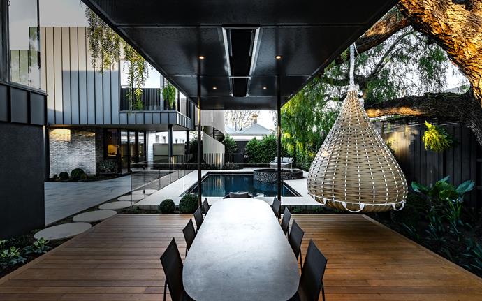 **Outdoor rooms:** It was a magnificent 100-year-old peppercorn tree that inspired the design of this backyard haven. A steel pergola covers the outdoor dining area and features a timber deck, integrated heating, down lights, bar fridge and barbecue. <br> 
*Design by Mint Pool and Landscape Design and Mil Constructions; [mintdesign.net.au](https://mintdesign.net.au/|target="_blank"|rel="nofollow"), [milconstructions.com.au](https://www.milconstructions.com.au/|target="_blank"|rel="nofollow")*