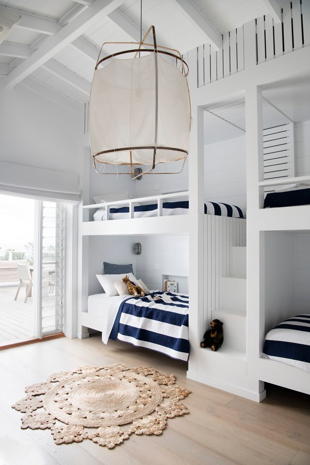 The nautical-style kids' bedroom brings a ship's cabin to mind and promises hours of salty fun spent on holidays in [this fresh and airy south coast beach house](https://www.homestolove.com.au/hamptons-beach-house-gerroa-23265|target="_blank"). Each bunk has its own reading light and a nook recessed into the wall to store holiday books and treasures.