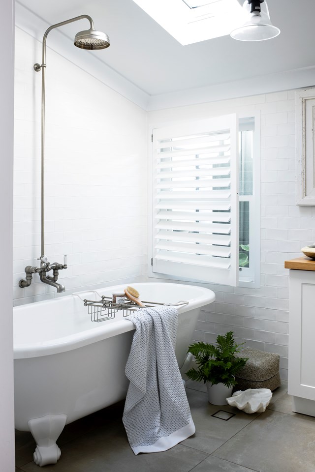 Small bathroom shower designs can be challenging so it makes sense to double up on functionality where possible. The overhead shower in [this Hamptons-style beach house bathroom](https://www.homestolove.com.au/hamptons-beach-house-gerroa-23265|target="_blank") allows for quick washdowns after the beach, or long relaxing soaks any time of day.