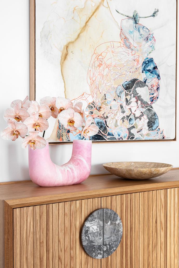 Bursts of colour give this home personality, including the artwork by Belinda Fox, and vase and platter from Dinosaur Designs that sit on a Zuster sideboard at the front entrance.