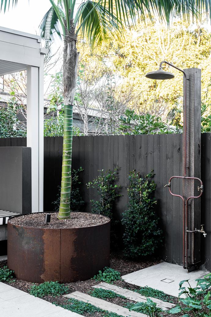 An outdoor shower sits between the cabana in the backyard, and the family's chill-out space just inside, creating a seamless indoor-outdoor connection.