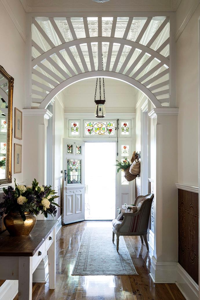 The entrance hall features a Federation-style 'Sunrise' pattern and pressed metal ceilings. The paint colour used throughout is Dulux Antique USA.