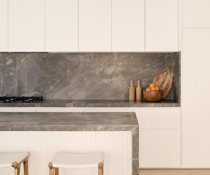 Classic matte-white joinery allows the Hermes marble benchtops and splashback to be the star of the kitchen. The stone provides "a juxaposition of city and sea, light and shade," Jayden tells. [CLO Studios](https://clostudios.com.au/|target="_blank"|rel="nofollow") leather flat bar stools provide textural variation.