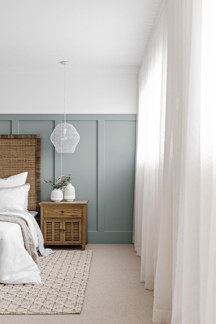 The master suite features a decorative wainscotting painted in Taubmans 'Lazy Days'. The bedding is all from Cultiver, and the pendant light is the Lumu Metal Wire Pendant White from Living Styles.
