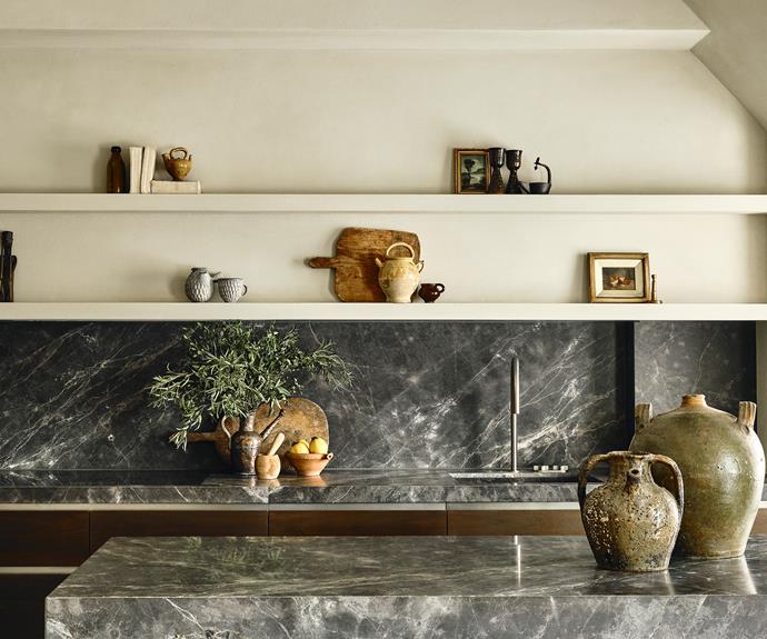 The Banda kitchen designed by Obumex takes a more modern approach to luxury living, with Gaggenau appliances and handsome dark grey marble. American walnut doors add wamth. Clay pots from local shops and markets around the world are displayed on benchtops and open shelves.