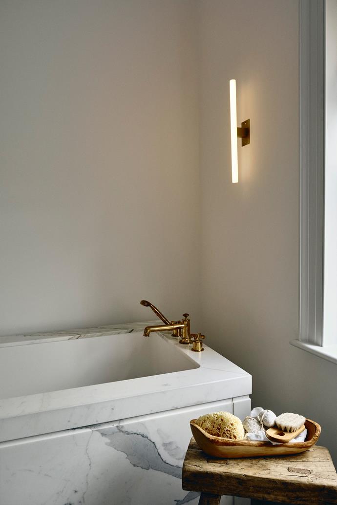 Marble makes a statement in the bathroom. The tapware is from Waterworks and the wall lamp is from [Kaia Lighting](https://kaialighting.com/|target="_blank"|rel="nofollow").