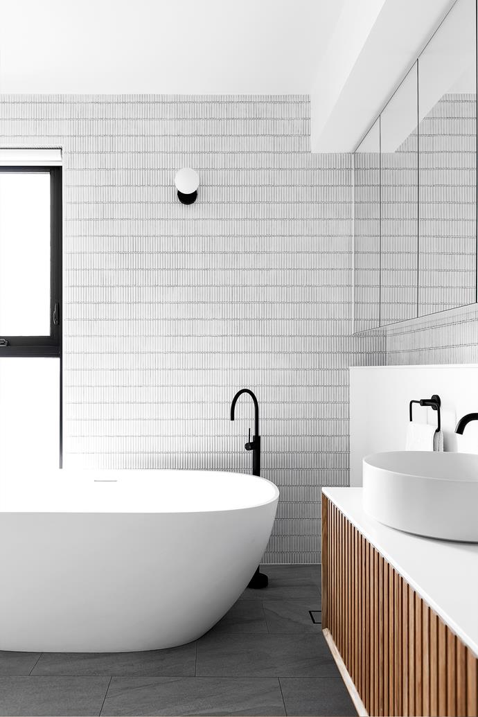 An elegant [Kado](https://www.reece.com.au/search/kado-b142000/?pageNumber=1|target="_blank"|rel="nofollow") bathtub is the focal point of the main bathroom and pairs nicely with the [Parisi](https://parisi.com.au/|target="_blank"|rel="nofollow") basin. Also atop the Halo III vanity from [Reece](https://www.reece.com.au/|target="_blank"|rel="nofollow") is tapware from [Phoenix](https://www.phoenixtapware.com.au/|target="_blank"|rel="nofollow"). Wall tiles and floor tiles, [Academy Tiles](https://www.academytiles.com.au/|target="_blank"|rel="nofollow"). Orb light, [Lighting Collective](https://lightingcollective.com.au/|target="_blank"|rel="nofollow").
