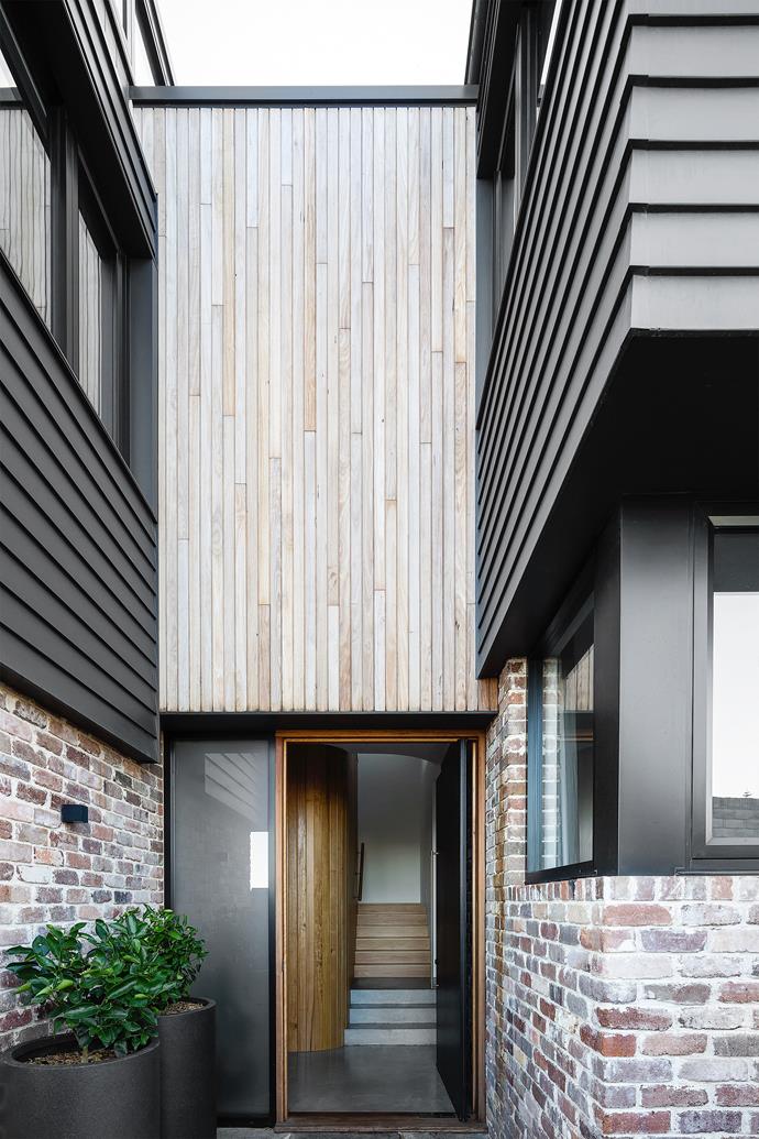 Above the front door, the blackbutt shiplap cladding is vertical, emphasising the height of the home. The stairs to the upper floor, which contains the living spaces, are positioned by the front door so visitors don't walk through the family's private rooms.