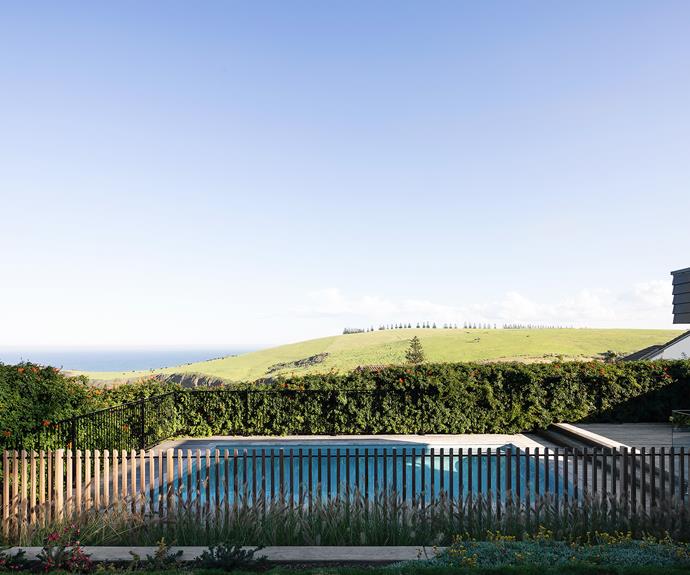 The landscape design by [Formed Gardens](https://formedgardens.com.au/|target="_blank") acts as a windbreak for the pool area. Robertson Collectif painted the home's weatherboard cladding with Blackwood Bay by Dulux and used recycled bricks for a textured look.