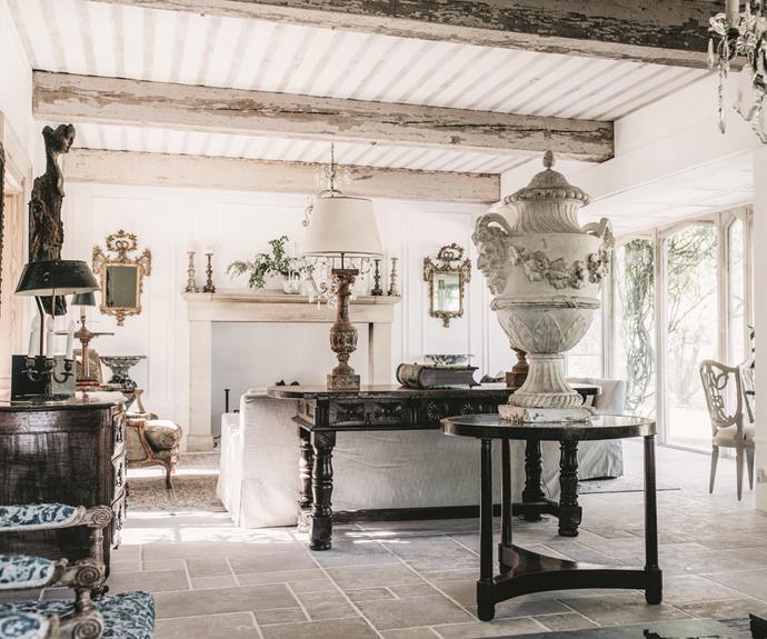 At Wollumbi Estate, floor-to-ceiling windows bring the outdoors in, creating a natural backdrop for the curated mix of 18th and 19th-century French tables, lamps and statues.
