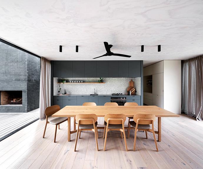 "One of our favourite rooms is the open-plan kitchen space," says Rachelle. To the right is a concealed fridge and bar area. A statement black Radical fan by [Hunter Pacific International](https://www.hunterpacificinternational.com/|target="_blank"|rel="nofollow") and black cylinder downlights were chosen to offset the surrounding white-washed plywood of the walls and celiling. Cabinetry by Everclear Constructions. Timber dining table and chairs, [Jardan](https://jardan.com.au/|target="_blank"|rel="nofollow"). Curtains, from a local supplier.