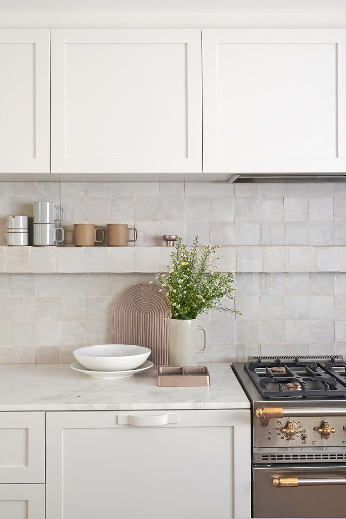 An open shelf makes the kitchen feel inviting. Elba marble from [Signorino Tile Gallery](https://www.signorino.com.au/|target="_blank"|rel="nofollow") was the stone of choice for the benchtops in the kitchen. Handmade Moroccan zellige tiles from [Byzantine Tiles](https://byzantinedesign.com.au/|target="_blank"|rel="nofollow") on the splashback bring the room to life by bouncing light around. The cooker is [Lacanche](https://www.lacanche.com/|target="_blank"|rel="nofollow") and the mugs on the tiled display shelf are by [Hasami Porcelain](http://www.hasami-porcelain.com/about/en.html|target="_blank"|rel="nofollow").