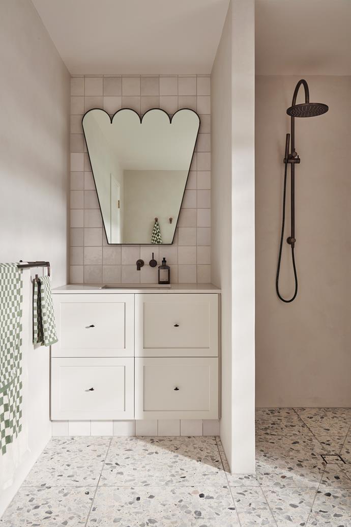 Because this room is mostly used by kids, we wanted to introduce a touch of playfulness," says Georgina of the ground floor's main bathroom. A quirky custom-made mirror is set against handmade tiles from [Byzantine Tiles](https://byzantinedesign.com.au/|target="_blank"|rel="nofollow"). The shower is [Faucet Strommen](https://www.faucetstrommen.com.au/|target="_blank"|rel="nofollow") and the terrazzo floor tiles are from [Perini](https://www.perini.com.au/|target="_blank"|rel="nofollow").