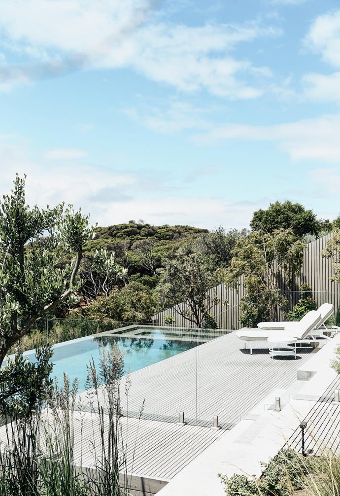 The swimming pool area at [this contemporary coastal abode](https://www.homestolove.com.au/contemporary-coastal-home-victoria-22859|target="_blank") in the Mornington Peninsula is a destination on its own, featuring thin timber decking that replicates the linear battens used throughout the interiors of the home. 