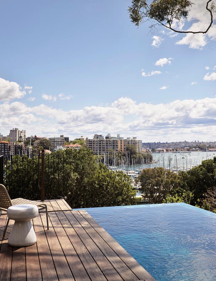 At [this modern three-level home](https://www.homestolove.com.au/modern-three-level-home-sydney-harbour-22160|target="_blank") overlooking Sydney harbour, a timber-decked infinity pool floats above the treetops, helping the spectacular house boldly defy its boundaries. 

