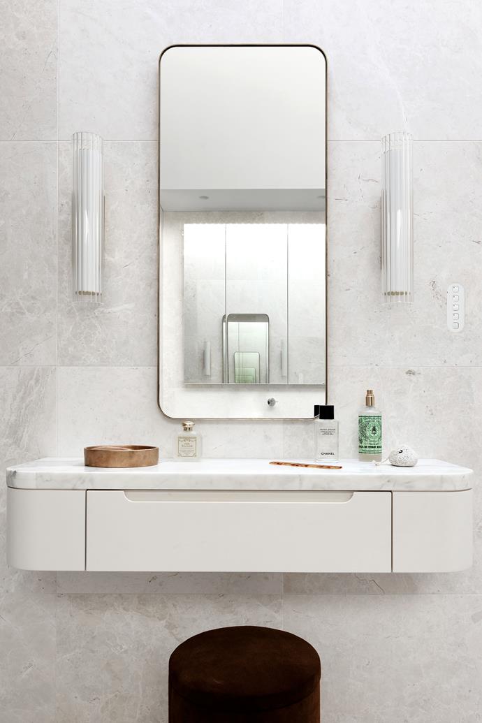 The French Cream marble wall tiles and bench top in the main ensuite are from WorldStone. On the vanity, the Santa Maria Novella fragrance is from Casa by Kate Nixon.
