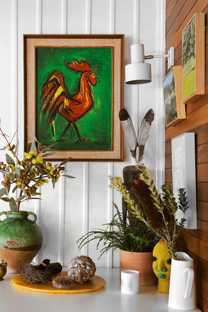 The red cockerel is a vintage print from Rudi Rocket. A pair of timber-framed oil paintings by David Whitworth and another work by Jake Walker hang beneath a vintage Danish light from Grandfather's Axe.