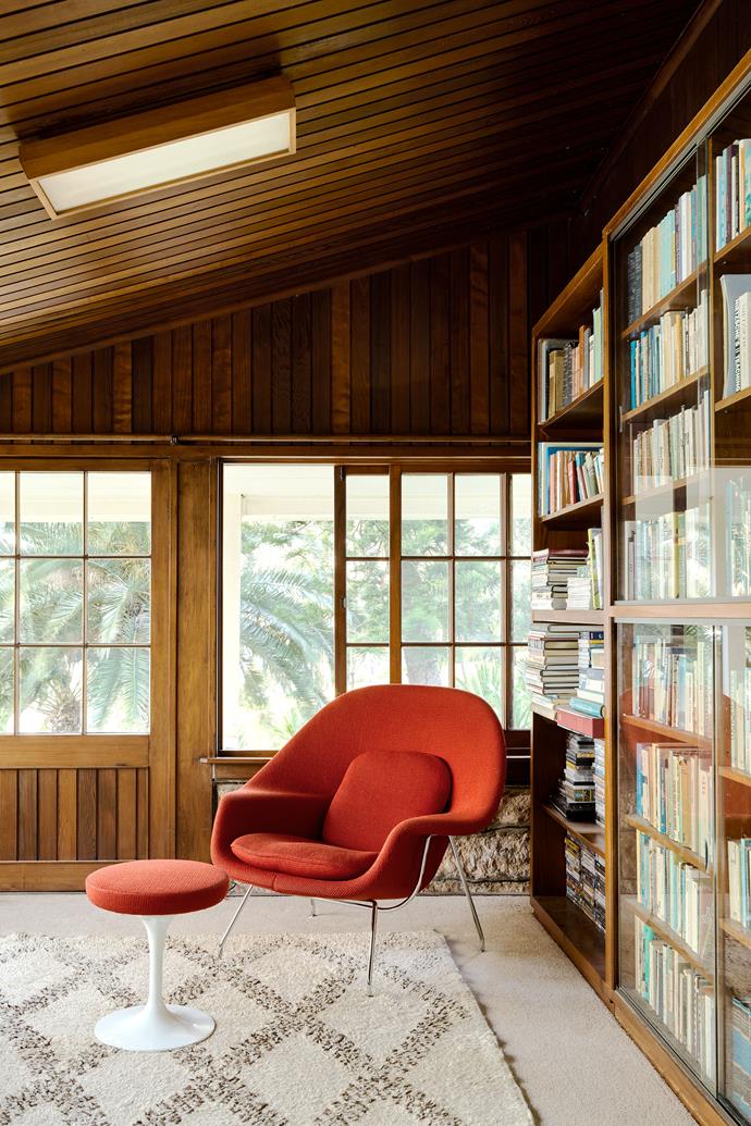 The Knoll 'Womb' chair and 'Tulip' stool by Eero Saarinen from De De Ce offers an appealing reading spot in the library where books fill the original shelves. Rug from Garden Life.