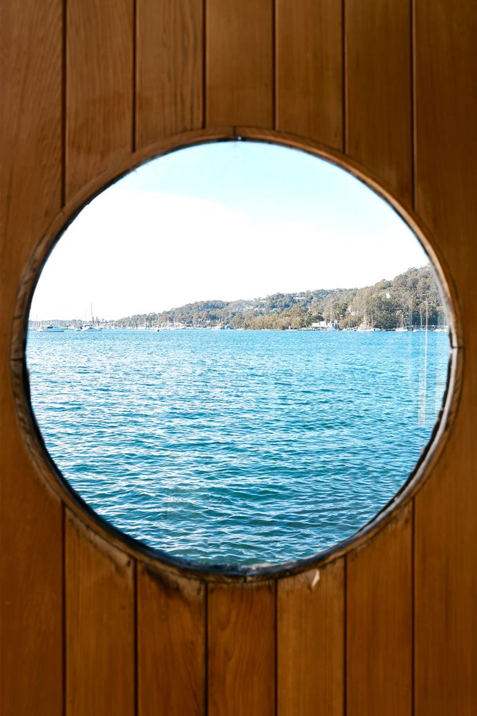 A porthole in the boatshed captures the Pittwater views.