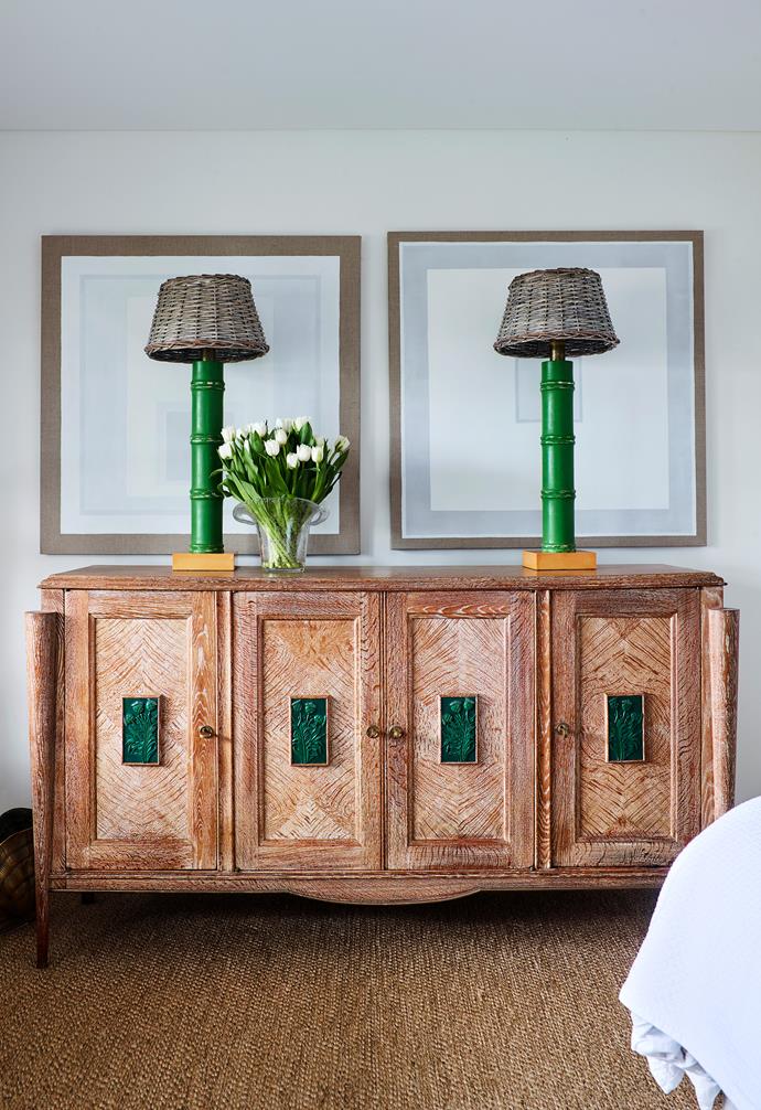 Verdigris copper inlays fronting a 1940s Belgian cabinet connect with the green of the mid-20th-century French lamps on top.