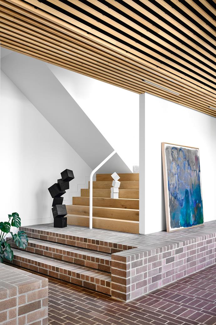When designing the modern extension of [this period home](https://www.homestolove.com.au/period-home-brave-extension-melbourne-23202|target="_blank"), the architect took cues for the new from the old. A feature band of dark bricks around the original red-brick house inspired the dusty-purple brick floor that takes centrestage in the new wing. 