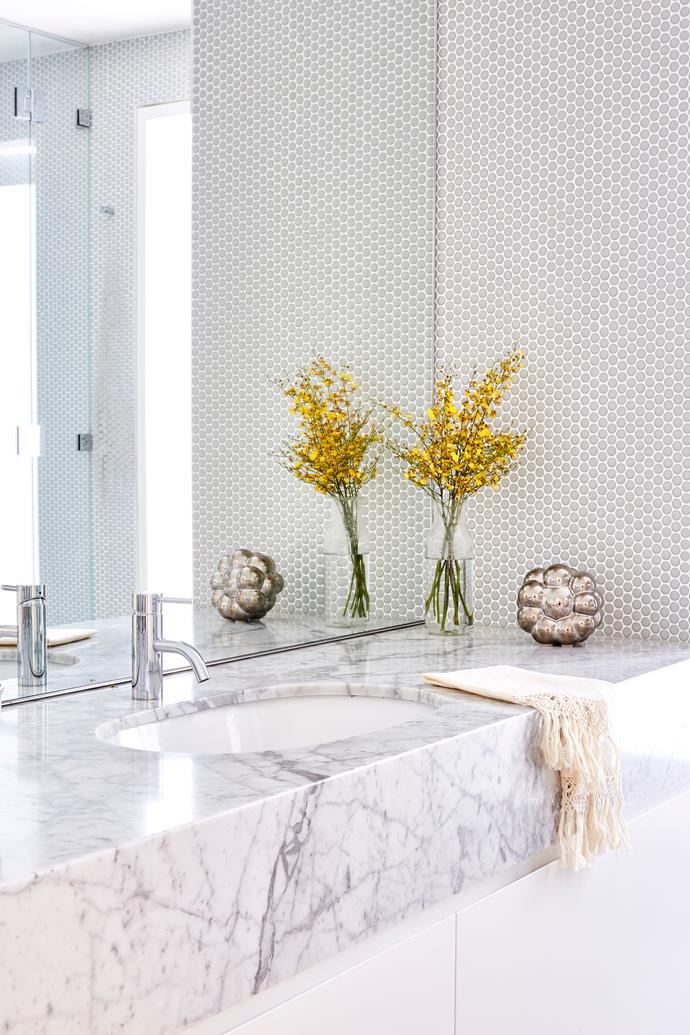 **ENSUITE** Penny rounds and Carrara marble evoke high-end glamour in the guest ensuite.