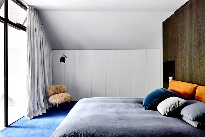 Sumptuous bed linen and cushions in rich colours from Jardan as well as a Baxter 'Nepal' chair by Paola Navone from Space bring softness to the clean lines of the modern bedroom.