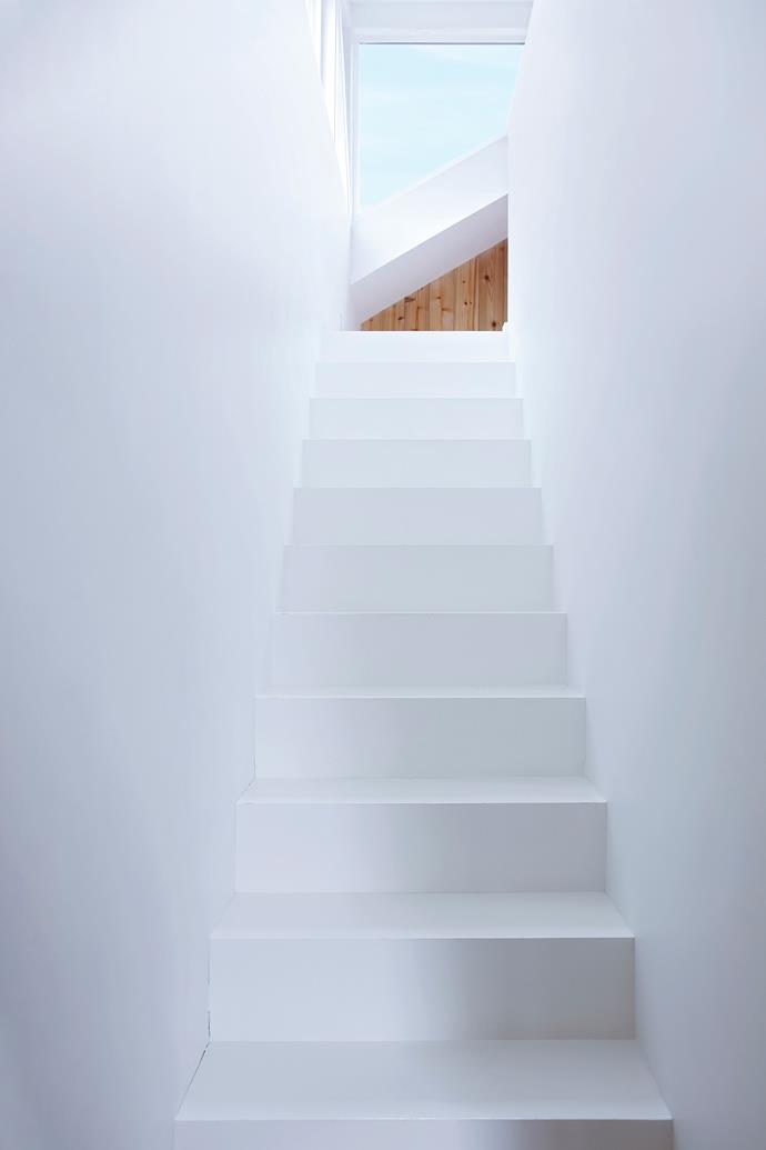 Painting the staircase white blurs the lines between walls and floor.