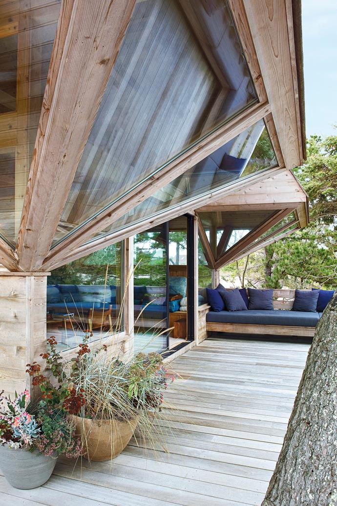 The 50-year-old beach home is predominantly timber. Much of the original wood had rotted and needed to be replaced by new owner Kearnon O'Molony. The shingled roof comes right down to meet the windows on either side of the recessed entrance to the living room. Built-in sofa, upholstered in Ralph Lauren fabric.