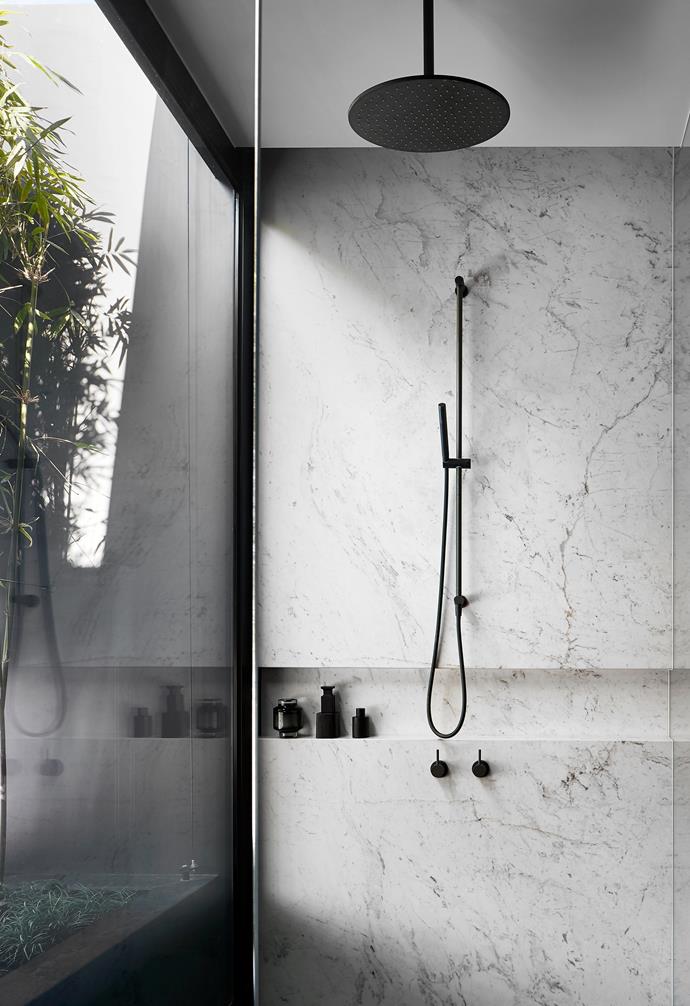 The black tap ware in the bathroom of [this minimalist Melbourne home with monumental proportions](https://www.homestolove.com.au/black-minimalist-melbourne-home-23100|target="_blank") picks up the black vein of the marble surrounds and styling, which creates a dramatic, yet cohesive statement. 