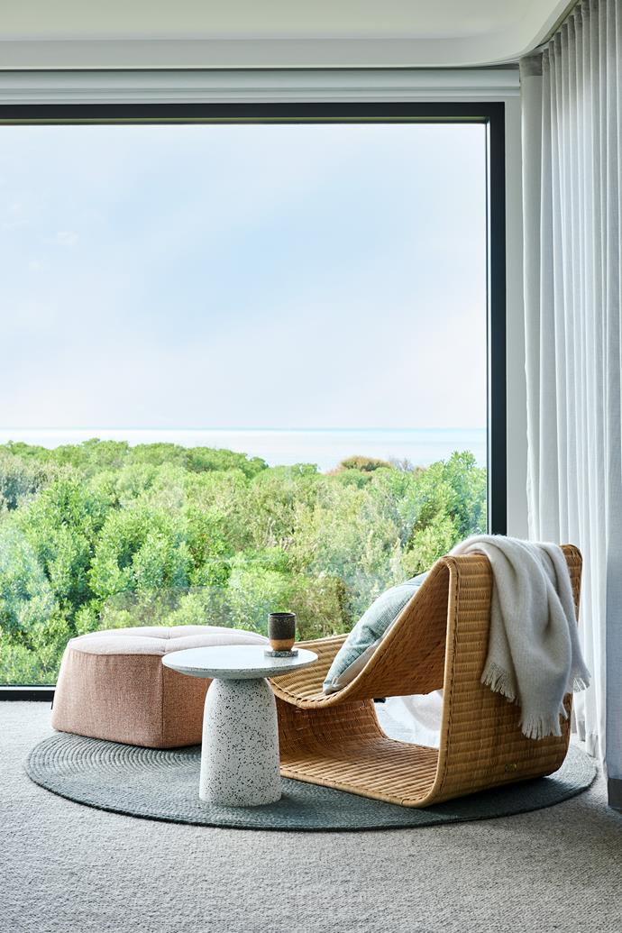 A quiet corner of Patrick and Mardi's space takes in the view. Arc lounger, [Worn](https://wornstore.com.au/|target="_blank"|rel="nofollow"). Natadora Arbor ottoman and Paloma side table, [GlobeWest](https://www.globewest.com.au/|target="_blank"|rel="nofollow"). Throw, [Royal Design](https://royaldesign.com/|target="_blank"|rel="nofollow").