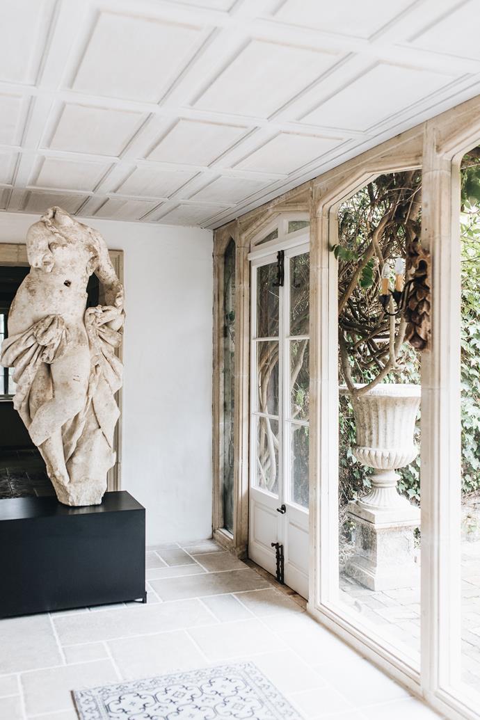 A dramatic addition to this hallway is the late 17th-century Bordeaux limestone sculpture of a classic life-size female. Outside is a French stone urn on a Venetian-style plinth.