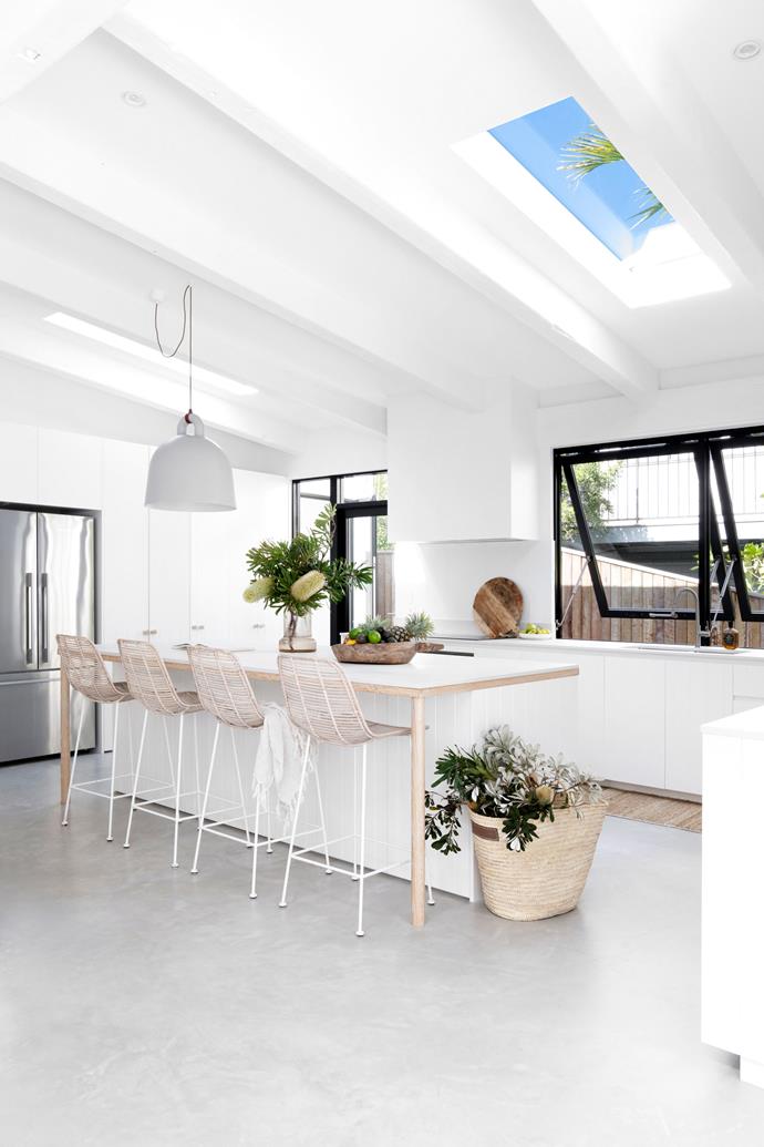 **KITCHEN** Once orange, taupe and poky, the new, white, bright kitchen feels fresh, timeless and far bigger thanks to a few clever tweaks that involved removing a wall and installing additional skylights. Cabinetry by [Akyrah Kitchens](https://akyrahkitchens.com.au/|target="_blank"|rel="nofollow"), colour matched to walls in Resene Half Black White, is simple and subtle, with the kitchen island defined with [VJ detailing](https://www.homestolove.com.au/why-we-love-timber-vj-panelling-22752|target="_blank") and shapely oak legs. To keep the palette pared back and functional, Caesarstone benchtops in 'Cloudburst Concrete' echo the tone and feel of the floors refurbished in a micro cement finish.