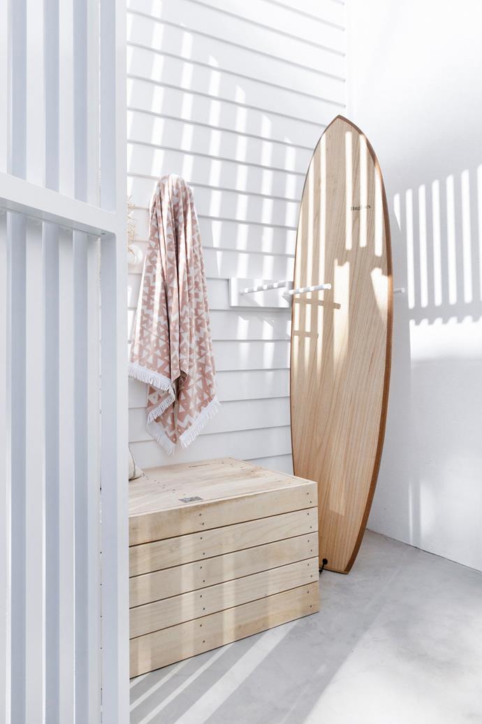 A custom timber box and board rack stores gear, including a locally crafted 'Flax Fish' surfboard from Hughies.