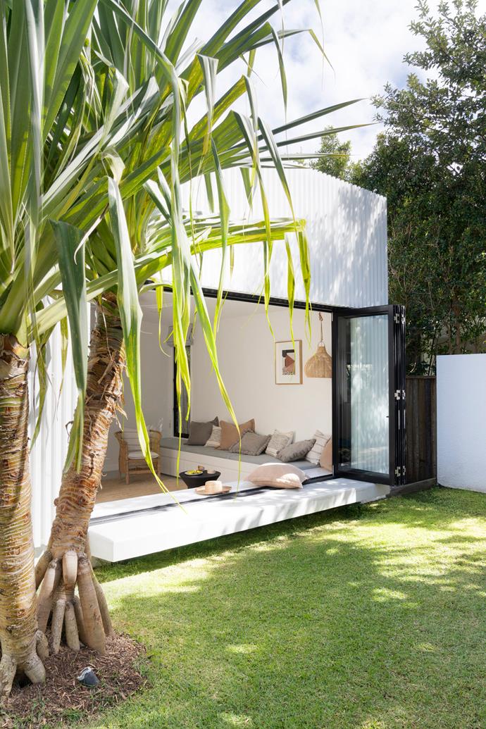 Simple, tropical plantings form the basis of this [luxe coastal home's](https://www.homestolove.com.au/luxe-neutral-coastal-home-noosa-23340|target="_blank") backyard. Throughout the spaces, a strong indoor-outdoor concept is carried through, with bi-fold doors and moveable perforated panels featuring strongly.