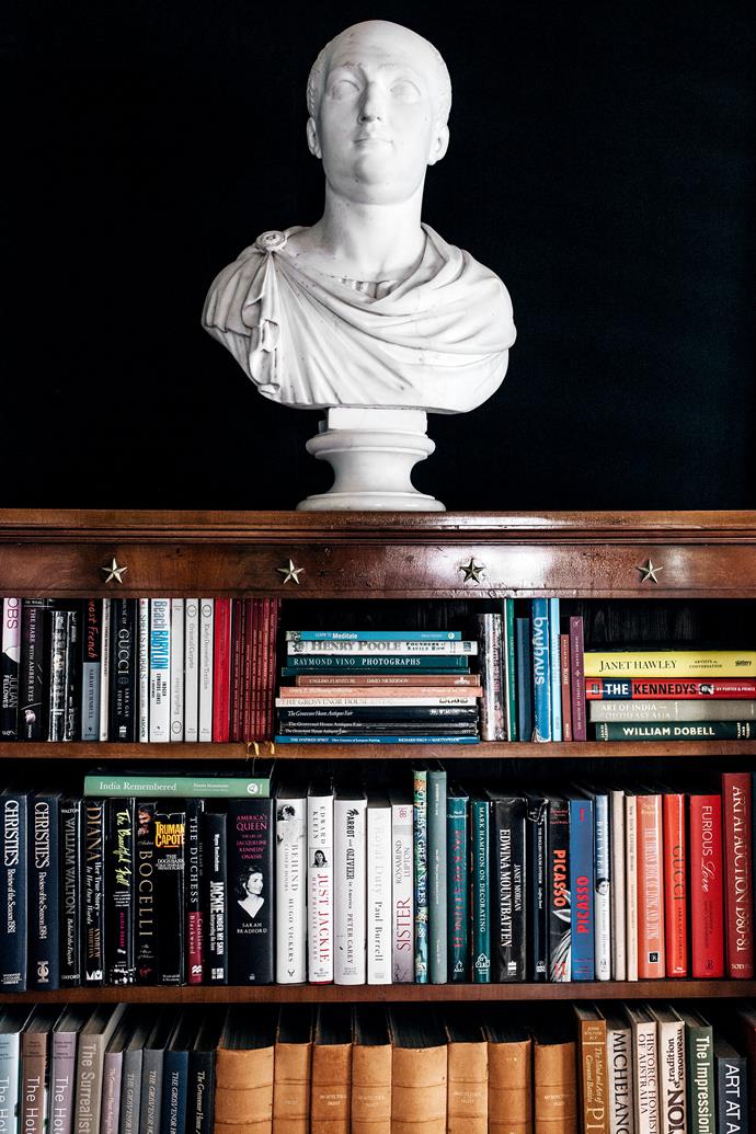 A 19th-century bookcase holds a Chinese bust.