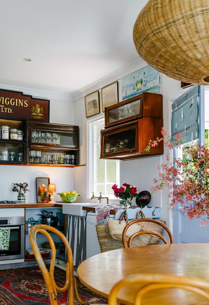**INSTALL A WALL-MOUNTED SHELVING UNIT**<br>
This [country style kitchen](https://www.homestolove.com.au/pink-lakeside-cottage-sunshine-coast-23361|target="_blank") forgoes a full-length splashback for a collection of salvaged and repurposed wall-mounted shelving units. A series of artworks adorn the space above one, while the other serves as a home to glassware and pantry essentials decanted in a series of retro-look jars and canisters.