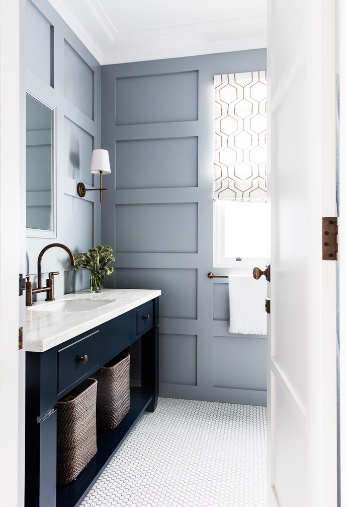In the bathroom of [this timeless family home with an element of luxe](https://www.homestolove.com.au/a-timeless-family-home-with-an-element-of-luxe-4878|target="_blank"), white penny round tiles are used on the floor, to balance out the feature walls. 