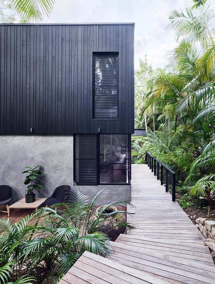[This luxe holiday home in Noosa](https://www.homestolove.com.au/a-luxury-noosa-holiday-home-by-mim-design-6146|target="_blank") is clad in treated and stained hardwood that links the house to its rainforest garden surroundings. 
