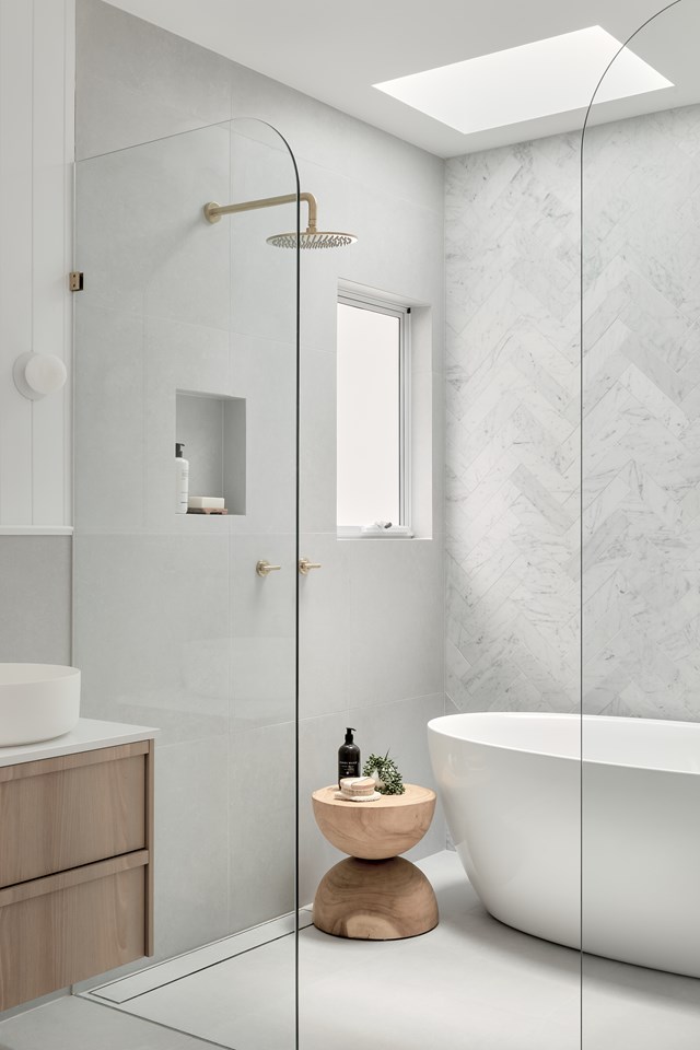 A simple grey and white palette is always a winner, and here we see it used to great effect. Brass tapware adds a point of difference, and a curved walk-in shower provides easy access. 