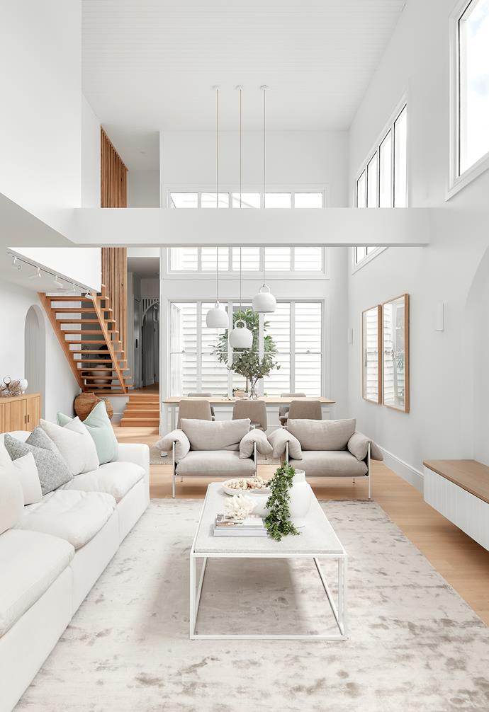 Bring an expansive space with double-height ceilings back 'down to earth' with furnishings that comfort and ground the senses. Think plush cushions, soft rugs and tactile ceramics.