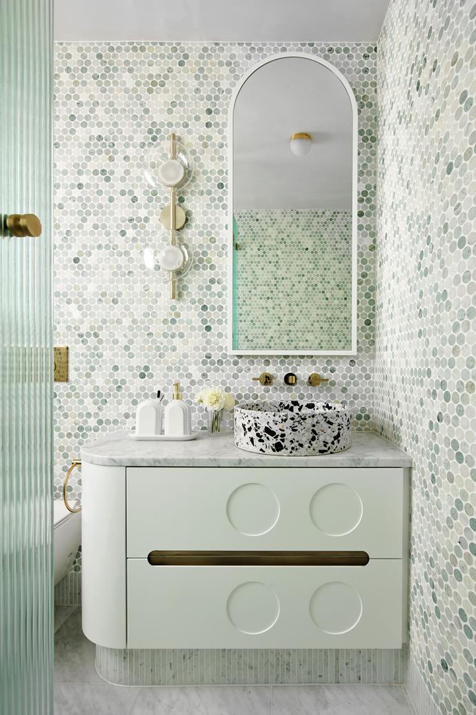 'Penny Round' mosaic tiles in Ming Green in the bathroom with honed Carrara pencil tiles beneath the custom vanity by Greg Natale and Carrara floor tiles, all from Teranova. Bentu 'Hui' terrazzo basin from Remodern.