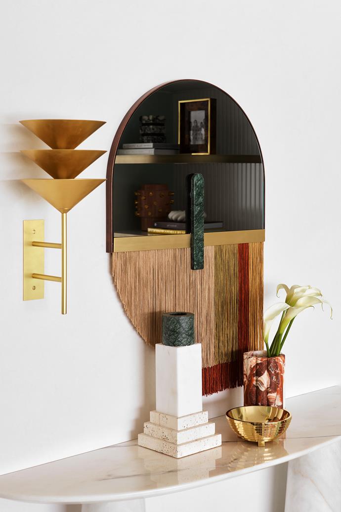 In the entry a 'Souk' mirror in Red from Regency Distribution is a statement piece, enhanced by ceramics from Greg Natale on the Brabbu 'Agra' console table from Covet House. 'Wall Stack 3' lamp in polished brass from Volker Haug.