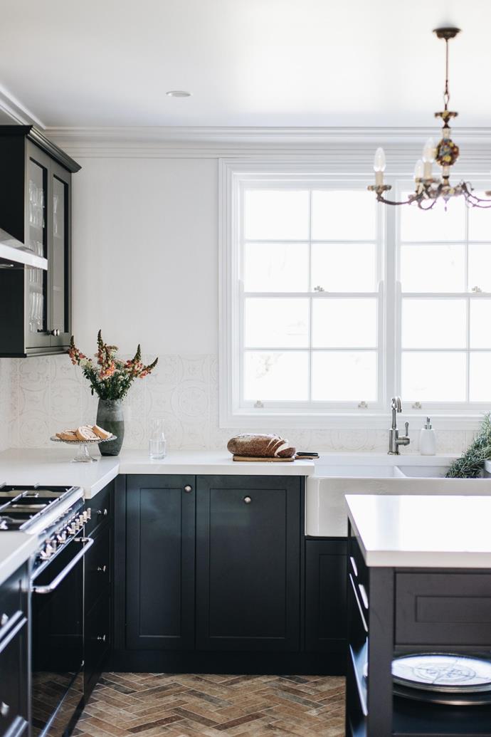 Featuring gorgeous dark cabinetry and an apron-front sink, the kitchen is [quintessential country cottage](https://www.homestolove.com.au/country-kitchen-design-ideas-13266|target="_blank").