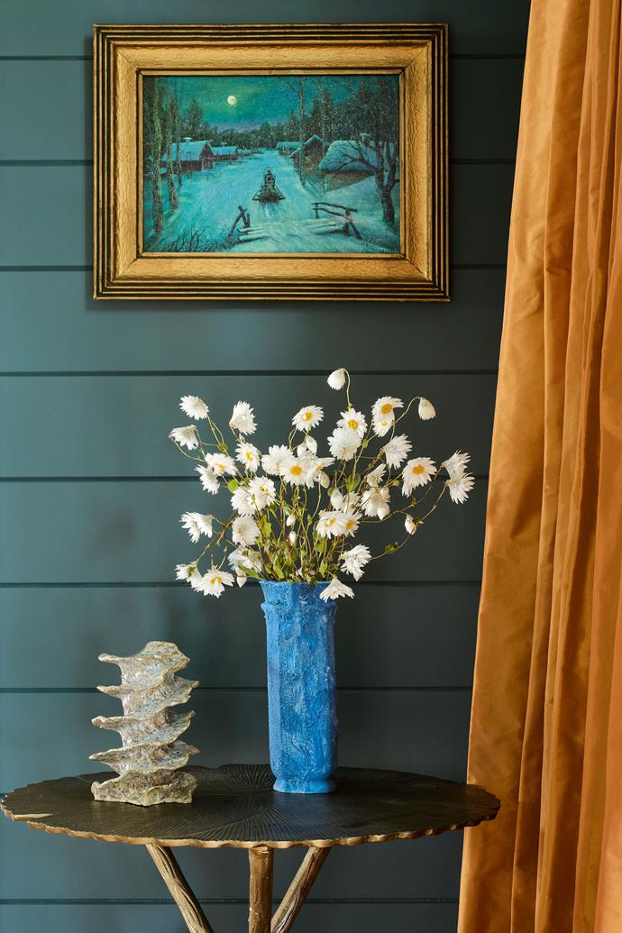 'Asteria' side table from [Koala Living](https://koalaliving.com.au/asteria-side-table|target="_blank"|rel="nofollow") with a vase and sculpture by Hilary Green. Vintage artwork from AM Art Projects. Mustard silk curtains from Marlow & Finch.