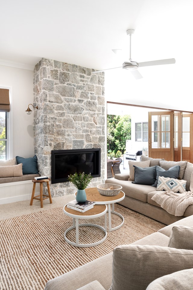 This stacked limestone wall houses a gas fireplace and anchors the living area of [this open plan family home](https://www.homestolove.com.au/modern-country-farmhouse-brisbane-23394|target="_blank"|rel="nofollow"). A window seat hugs the hearth and is lit by a small wall light to invite cosy reading.