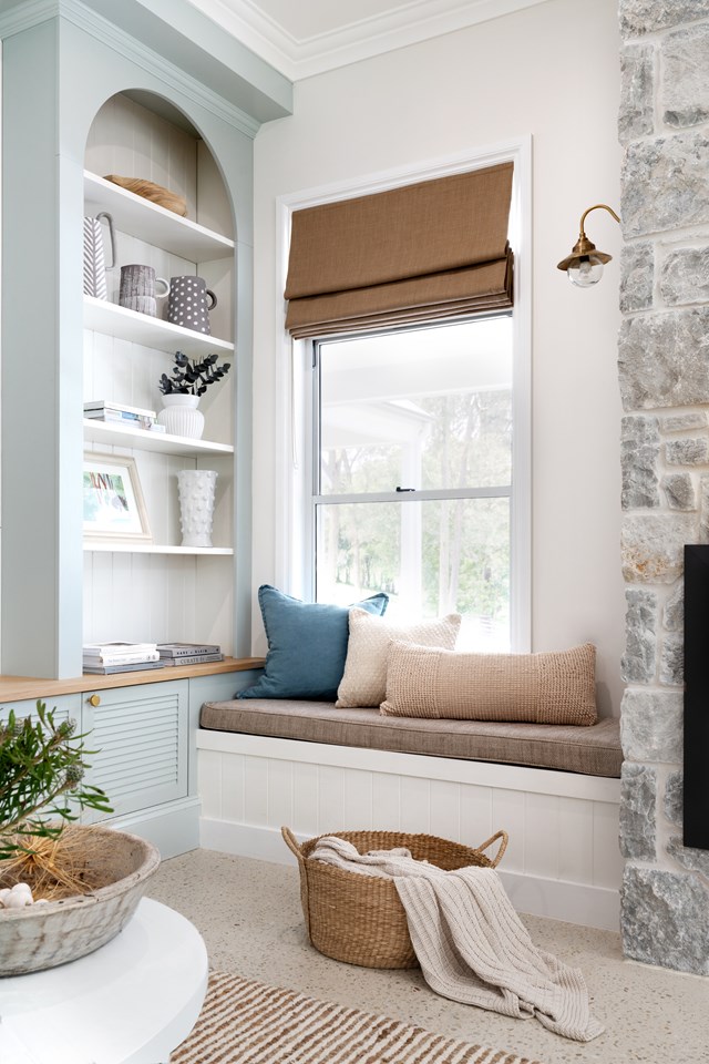 Sometimes the suggestion of a cosy reading nook is all that's needed. Decorative and functional, the snug spot next to the fireplace of [this country farmhouse](https://www.homestolove.com.au/modern-country-farmhouse-brisbane-23394|target="_blank") has a leafy outlook and is lit overhead for optimal evening reading.