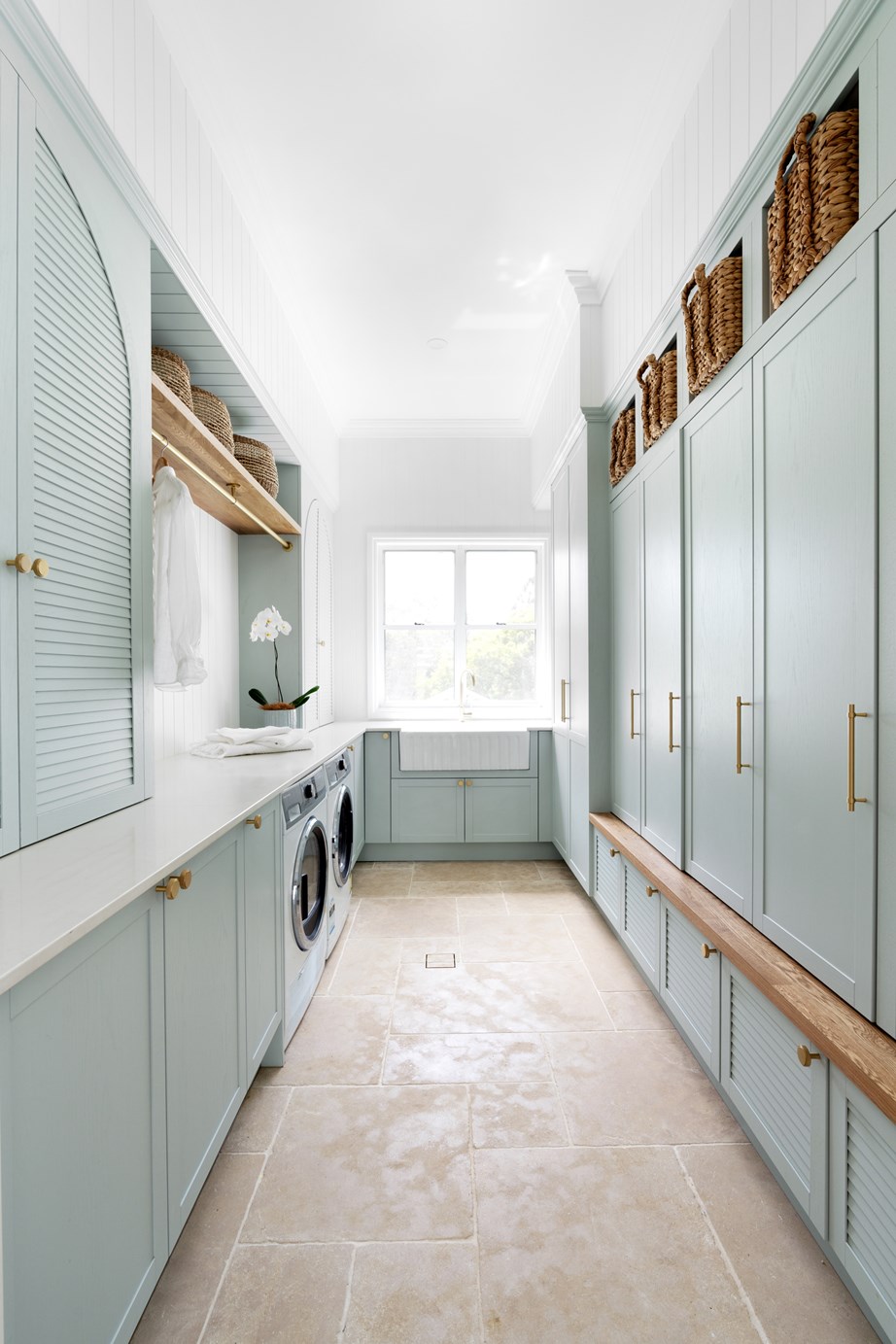 The laundry in this [modern farmhouse](https://www.homestolove.com.au/modern-country-farmhouse-brisbane-23394|target="_blank") features open shelves that provide space for pull-out baskets, and a brass hanging rail, from Passio Interiors, that comes in handy for hanging clothes.