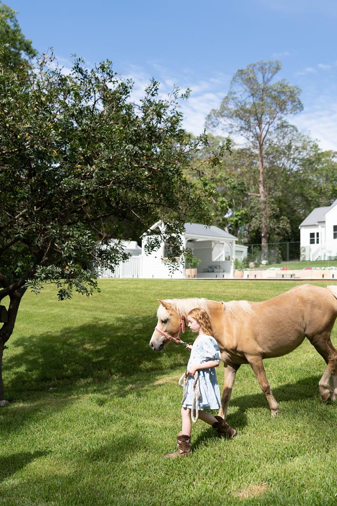 Ruby leads Rivi the palomino for a walk around the property.