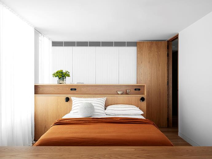 The sheers on the windows in the lower-level bedroom provide a breezy lightness to the interiors. The joinery is American oak veneer, and the bed linen is from [Cultiver](https://cultiver.com.au/collections/bedroom|target="_blank"). 